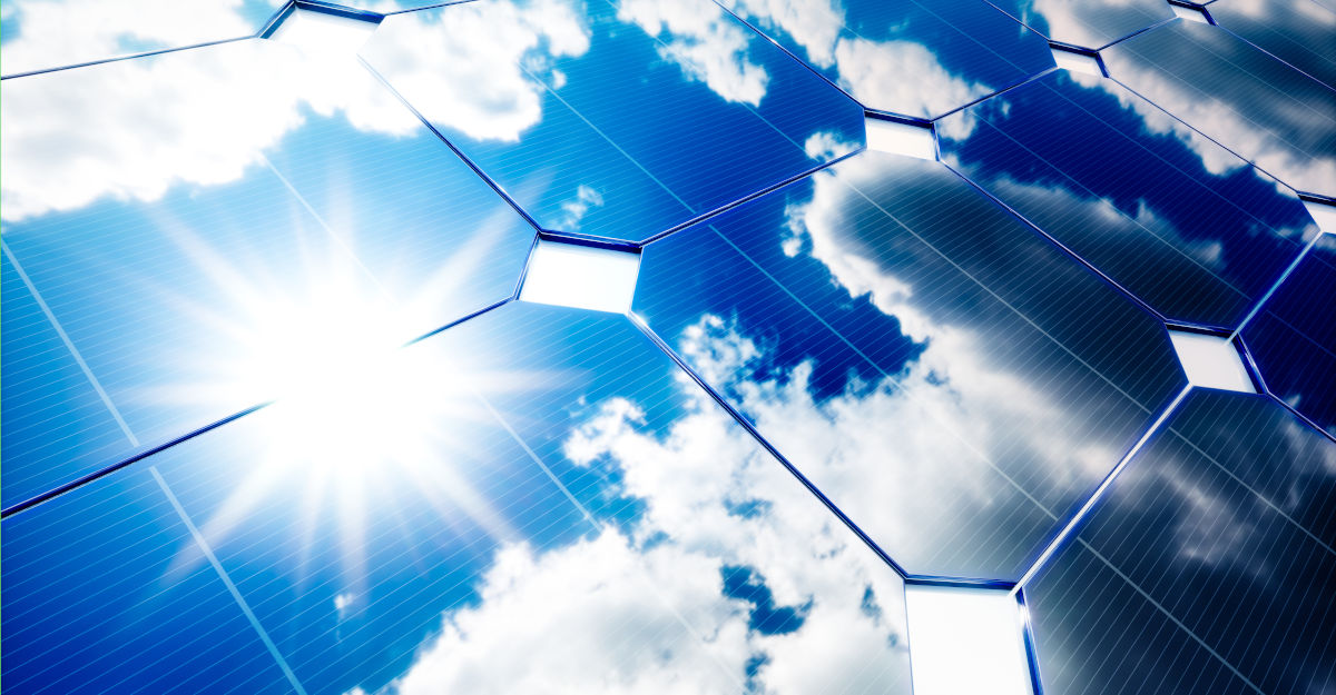 A close up of Sun Solar solar panels reflecting a bright blue sky.